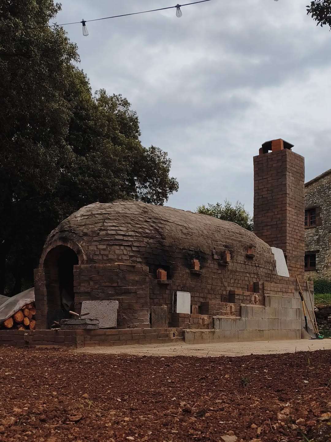 The Kujiragama anagama kiln and its brick chimney in front of the Can Brull masia.